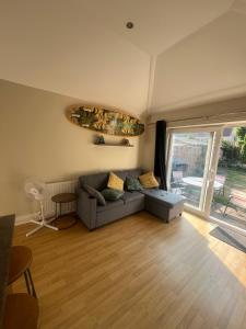 a living room with a couch and a large window at Open plan flat with large garden close to beach in Bournemouth