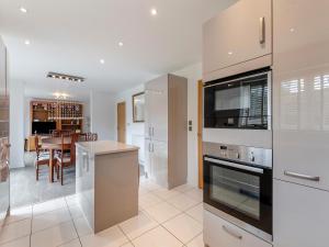 a kitchen with a stove top oven and a table at Carey in Eastchurch