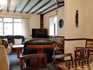 a living room with a chess board and a couch at Llys Cyngar in Porthmadog