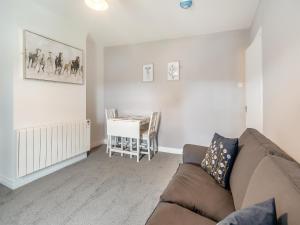 a living room with a couch and a table at Bluebell Apartment - Uk42381 in Bridlington