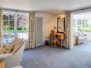a living room with a desk and a mirror at Beacon Cottage in Ivegill +29 photos