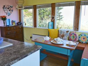 a kitchen with a table with cups and saucers on it at The Gallery in Mevagissey