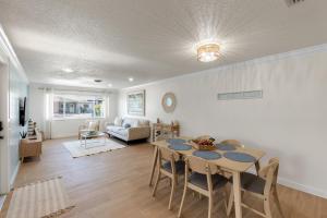 a dining room and living room with a table and chairs at Beach Getaway on Anna Maria Island in Holmes Beach