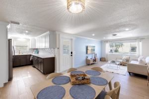 a kitchen and a living room with a table and chairs at Beach Getaway on Anna Maria Island in Holmes Beach