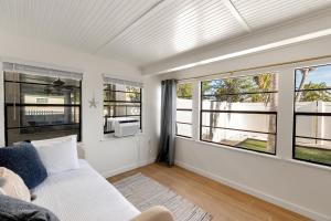 a living room with a couch and windows at Beach Getaway on Anna Maria Island in Holmes Beach