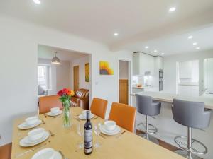 a kitchen and dining room with a table and chairs at Chestnut House in Bridgend