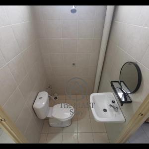 a bathroom with a white toilet and a sink at The MAST Stay "for islam people only" in Tampin +6 photos