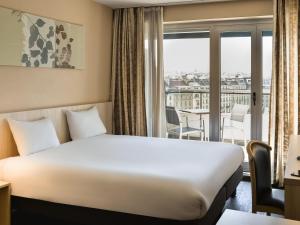 Postel nebo postele na pokoji v ubytování Aparthotel Adagio Genève Mont-Blanc