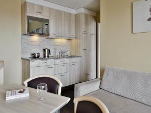 a living room with a couch and a table at Aparthotel Adagio Genève Mont-Blanc in Geneva