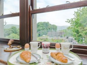 a table with two plates of croissants and eggs at Lillegarth in Bradwell +12 photos