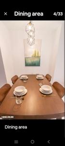 a dining room table with chairs and a chandelier at Eaton KL,1R1B,0 Service,300mbps,KLCC,2 pax in Kuala Lumpur