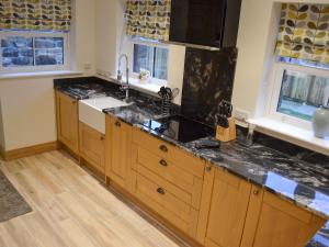 a kitchen with a sink and a counter top at Chancer in Newlyn