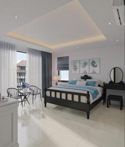 a bedroom with a bed and a table and chairs at Luna Oriental in Phu Quoc