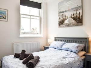 a bedroom with a bed with towels on it at Sea View Sanctuary in Scarborough +14 photos