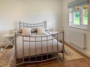 a bedroom with a metal bed and a window at Wild View in Rooks Bridge