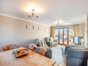 un salon avec une table et des chaises en bois dans l'établissement Chestnut Cottage - Uk45580, à Maltby le Marsh