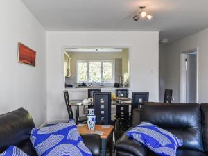 a living room with leather chairs and a table at Apartment 15 Harvest Moon in Newquay