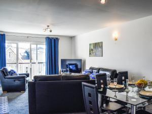 a living room with a couch and a table at Apartment 15 Harvest Moon in Newquay