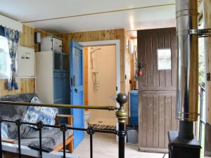 a room with a door and a room with a stove at Skipton Shepherd's Hut - Dales View in Cononley