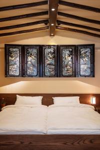 a bedroom with a bed with four windows at Korea's beauty in haeundae with Hinoki wooden bath in Busan