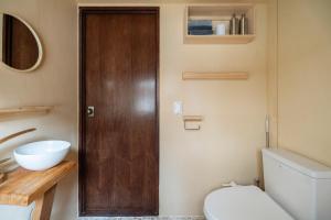 a bathroom with a toilet and a wooden door at Korea's beauty in haeundae with Hinoki wooden bath in Busan