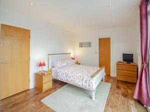a bedroom with a bed and a television in it at The Penthouse in Morfa Nefyn +19 photos