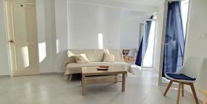 a living room with a couch and a table at Residência Alto Saco - Double Room with Shared Bathroom - Tarrafal de São Nicolau in Tarrafal