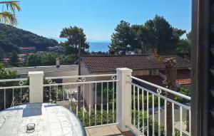 a balcony with a view of a house at Pet Friendly Apartment In Moscenicka Draga in Mošćenička Draga +17 photos