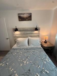 a bedroom with a bed with a blue comforter at Emmanuel Fulton Park Condominium in Tulsa
