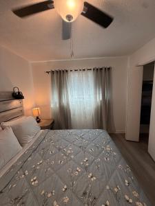 a bedroom with a bed and a ceiling fan at Emmanuel Fulton Park Condominium in Tulsa
