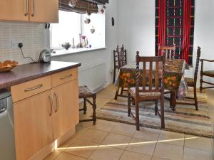 a kitchen with a table and two chairs and a table and a table at Lowmill in Kirkby Stephen +3 photos
