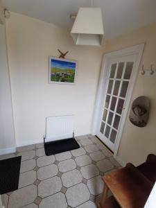 a living room with a table and a door at Charlie's House Relaxing Farmhouse near Letterkenny 