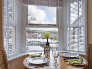 a dining room table with a view of the water at The Garden Apartment - Uk32517 in Whitby