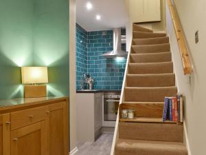 a staircase in a kitchen with blue tiles at The Garden Apartment - Uk32517 in Whitby