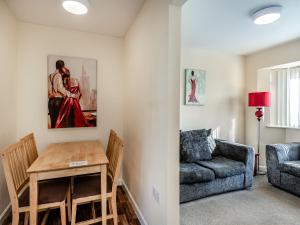 a living room with a couch and a table at Rainbow Bungalow 2 - Uk39810 in Chapel Saint Leonards
