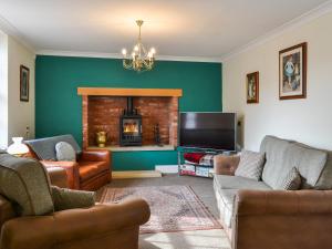 a living room with two couches and a fireplace at Beckbridge House in Pickering