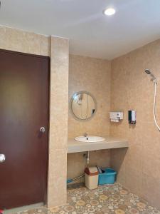 a bathroom with a sink and a mirror at Pluemjai mansion in Kathu +32 photos