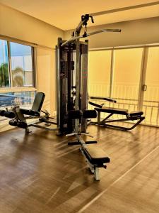 a gym with several treadmills and elliptical machines at Studio By The Sea in Dumaguete
