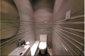 a small bathroom with a toilet and a sink at Quiet Professional Room in Bristol