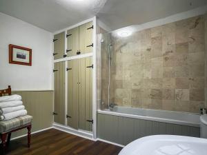 a bathroom with a shower and a bath tub at Market View in Ashbourne +1 photo