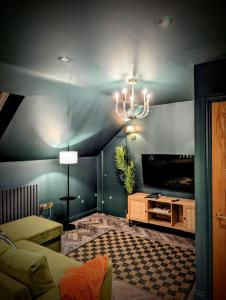 - un salon avec un canapé et un lustre dans l'établissement The Hideaway Bureau - Highlands, à Wooler
