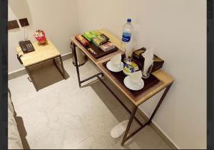 a small table with food and a water bottle on it at Gorgeous villa near Eden beach in Puducherry