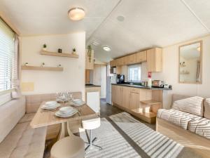 a kitchen and living room with a table and a couch at Vanhalla in Morecambe