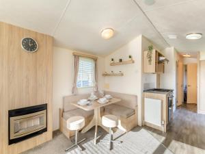 a small dining room with a table and a fireplace at Vanhalla in Morecambe