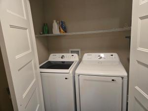 a small laundry room with a washer and dryer at Where Class Meets Comfort in Knoxville