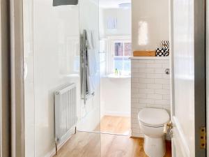 a bathroom with a toilet and a sink at The Knights Apartment, Eastbridge Hospital in Canterbury +5 photos