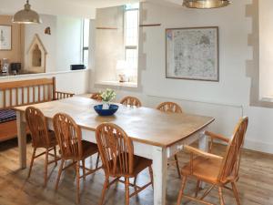 a dining room with a wooden table and chairs at St Peters in Highway