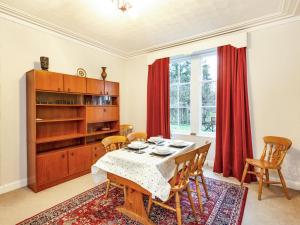 a dining room with a table and chairs at Isla Bank Cottage in Keith