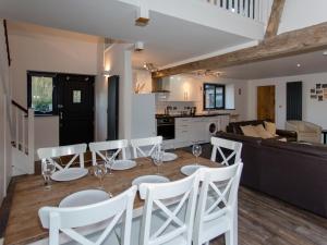 a dining room and living room with a table and chairs at Willow Barn - Fernhill Farm in Wootton Bridge +21 photos