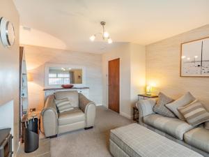 a living room with two chairs and a couch at Gan Hyem in Beadnell